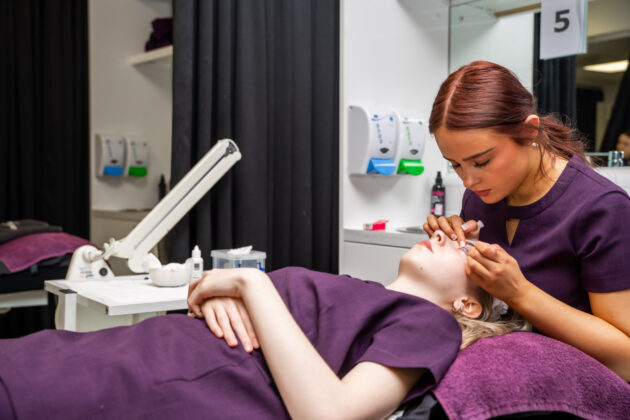 A Rotherham College beauty student working on a client in the salon